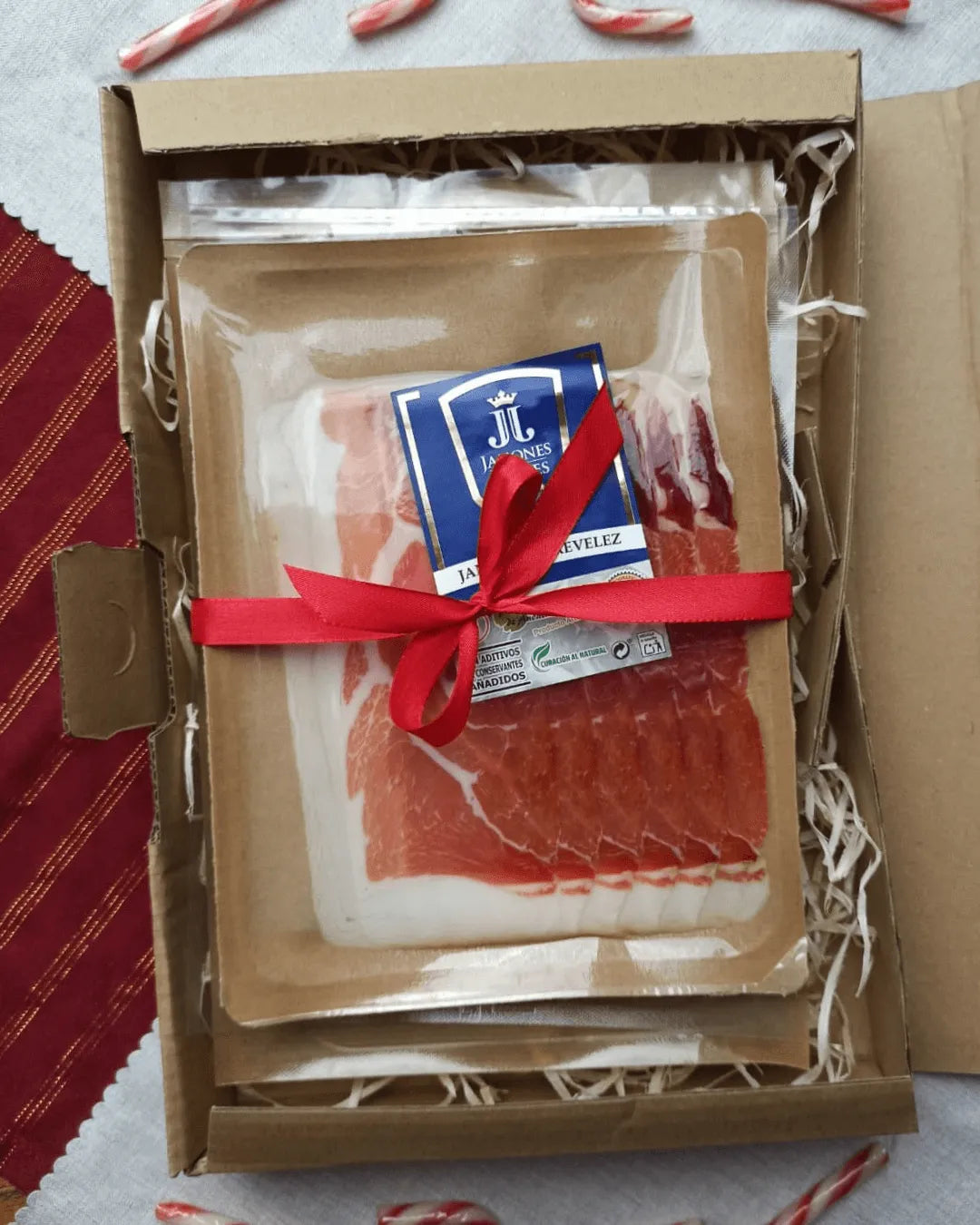 Serrano Geschenkset mit drei Sorten Schinken in Blisterpackungen, dekorativ mit roter Schleife verpackt