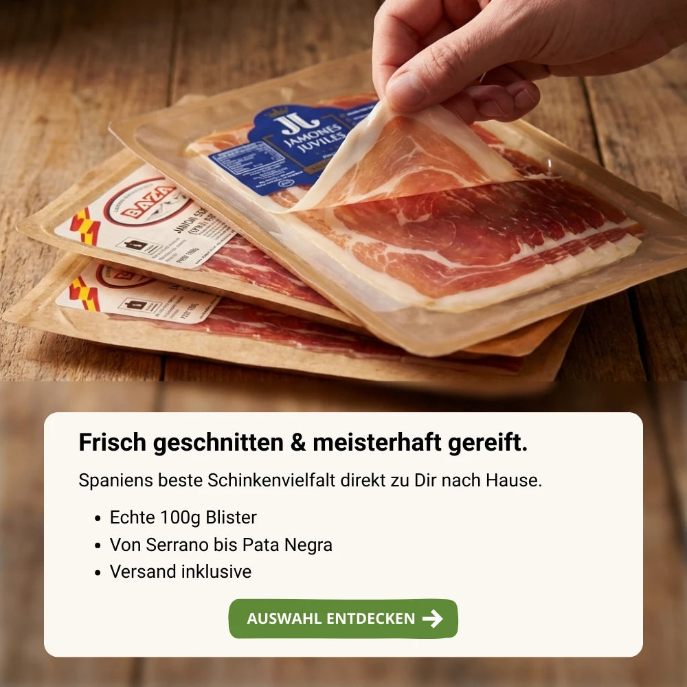 Hand nimmt eine dünn geschnittene Scheibe spanischen Schinkens aus einer vakuumierten Verpackung, mehrere Schinkenpacks auf rustikalem Holztisch, Fokus auf Frische und feine Marmorierung